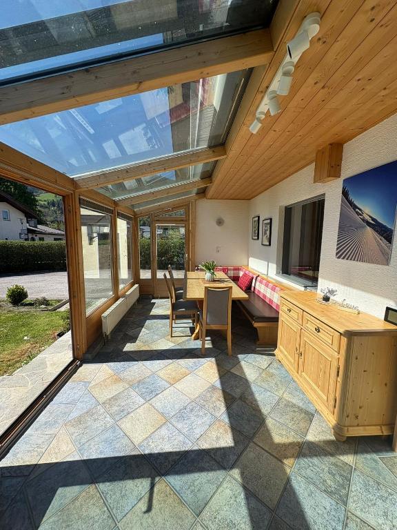 a living room with a large window and a couch at Chalet Frieda by Via Montes in Zell am See