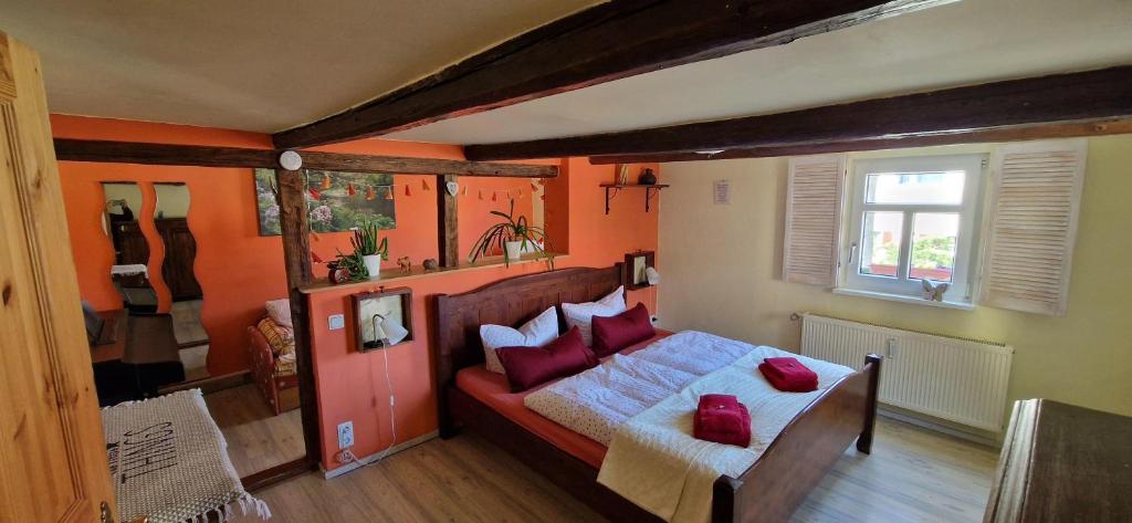 a bedroom with a bed with red pillows on it at Fewo2-Fliegenpilz in Bad Suderode