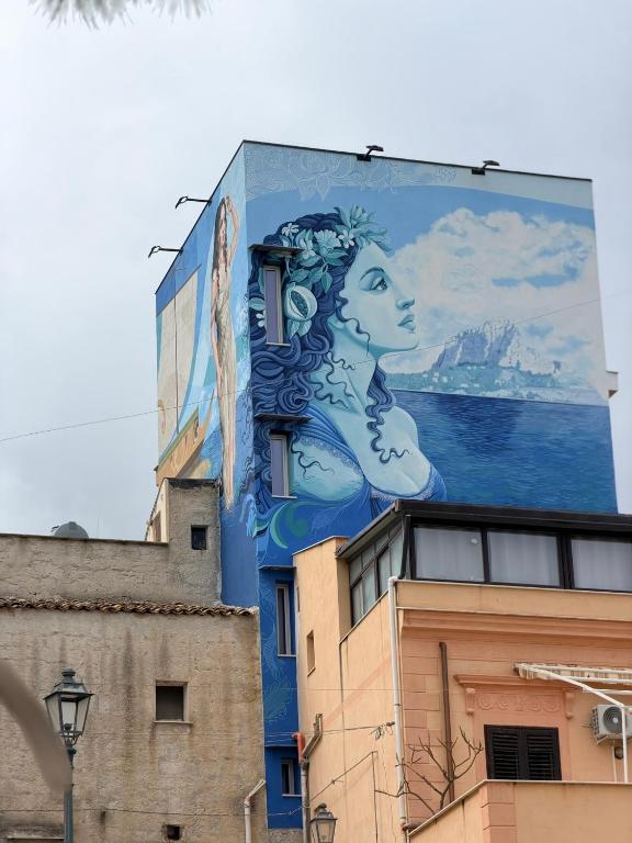 a large mural on the side of a building at Paloma in Santa Flavia