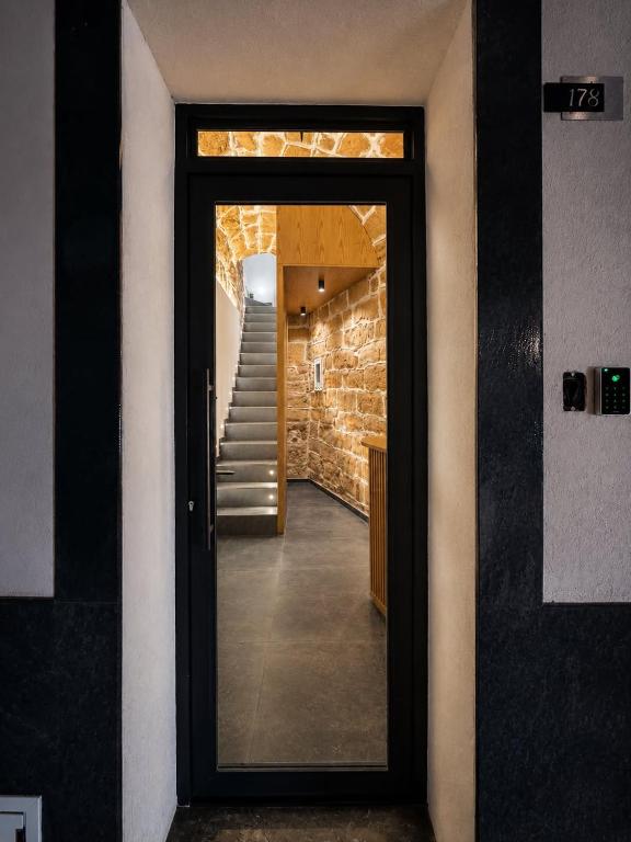 a door leading to a hallway with a staircase at B&Suite Le Meraviglie in Terrasini