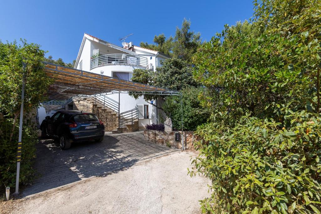 a car parked in front of a house at Apartments with parking space Zavala, Hvar - 8710 in Jelsa