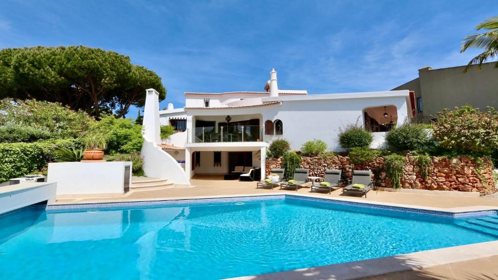 a villa with a swimming pool and a house at Villa Oasis by Cleverdetails private pool, walk distance in Vilamoura