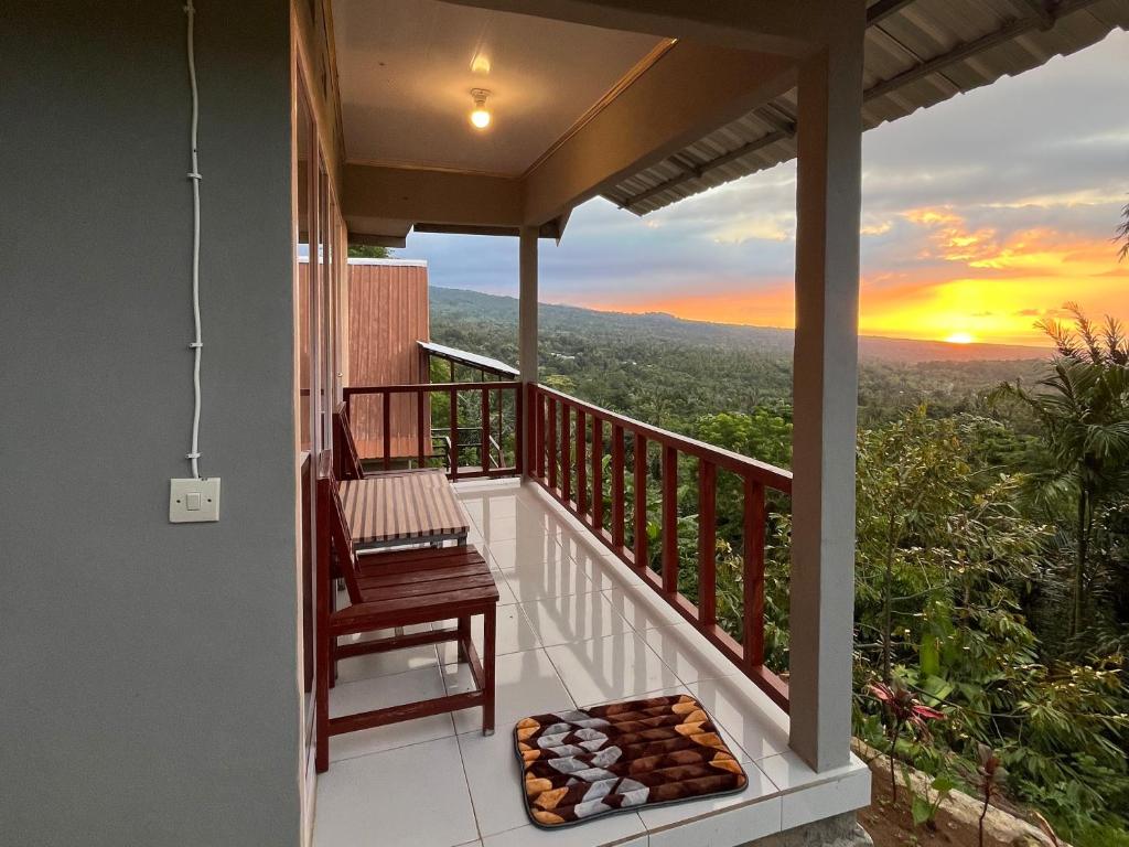 a balcony with a view of the sunset at Diva sunset garden in Senaru