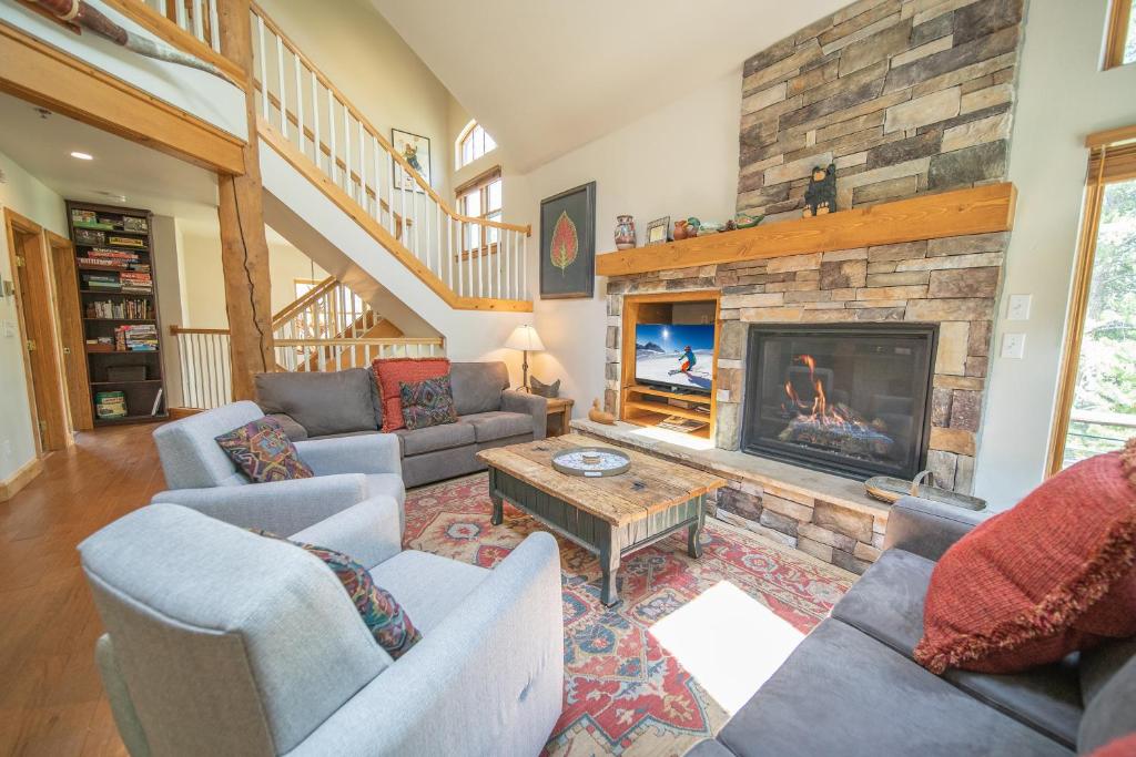 a living room with couches and a fireplace at Starfire 1979 by SummitCove Lodging in Colorado in Keystone