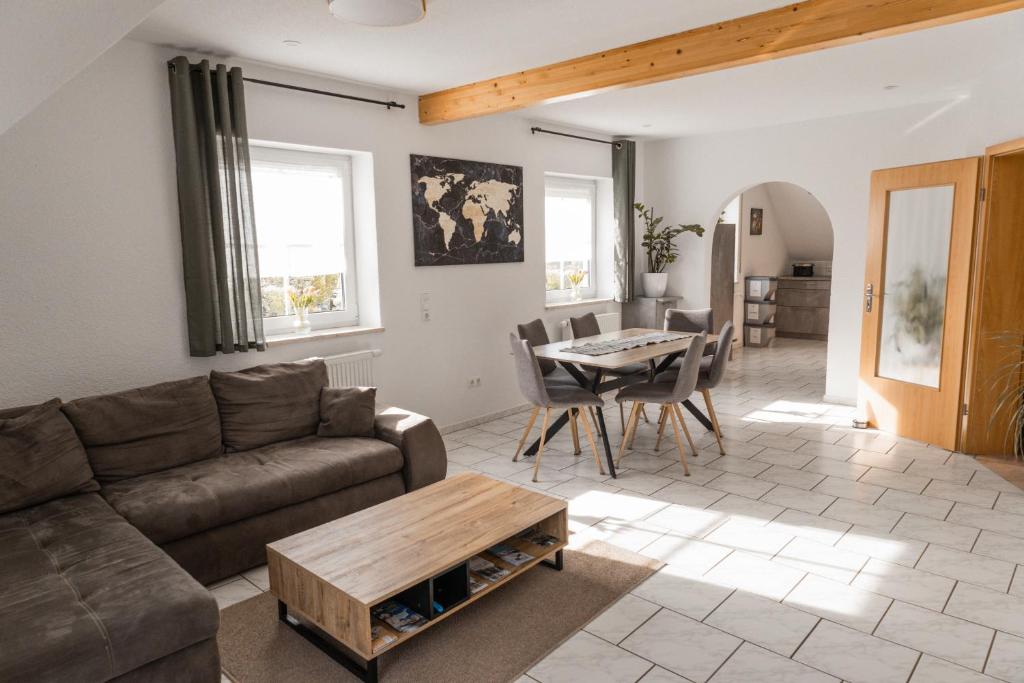 a living room with a couch and a table at Ferienwohnung Weigl Komfort in Nittenau