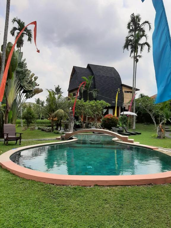 a swimming pool in front of a resort at Ubud Hidden Villa Yone village in Ubud