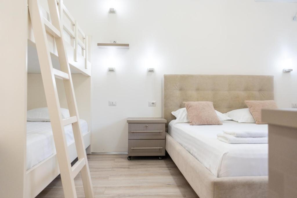 a bedroom with a bunk bed and a ladder at Le Monde 2 in Borsh
