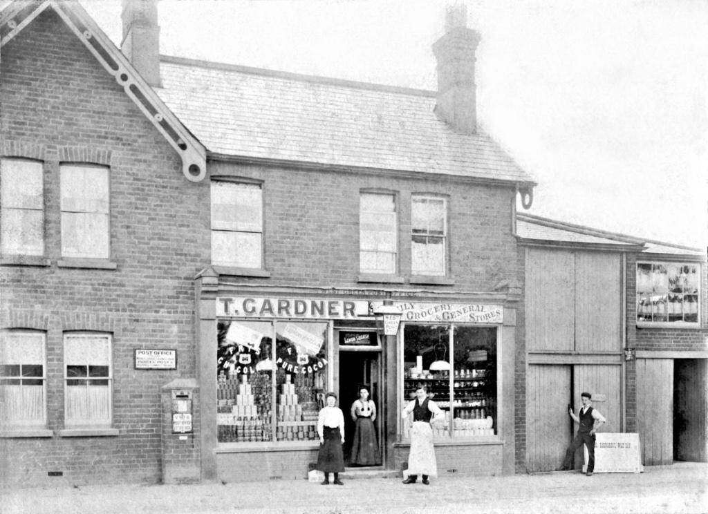 a group of people standing outside of a store at Blue Room in Ifield