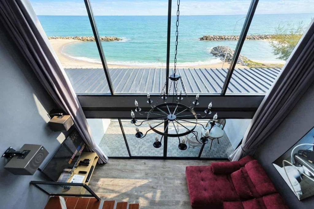 a view of the ocean from a room with a chandelier at Beachside Hotel H8 in Ban Nong Si Tong