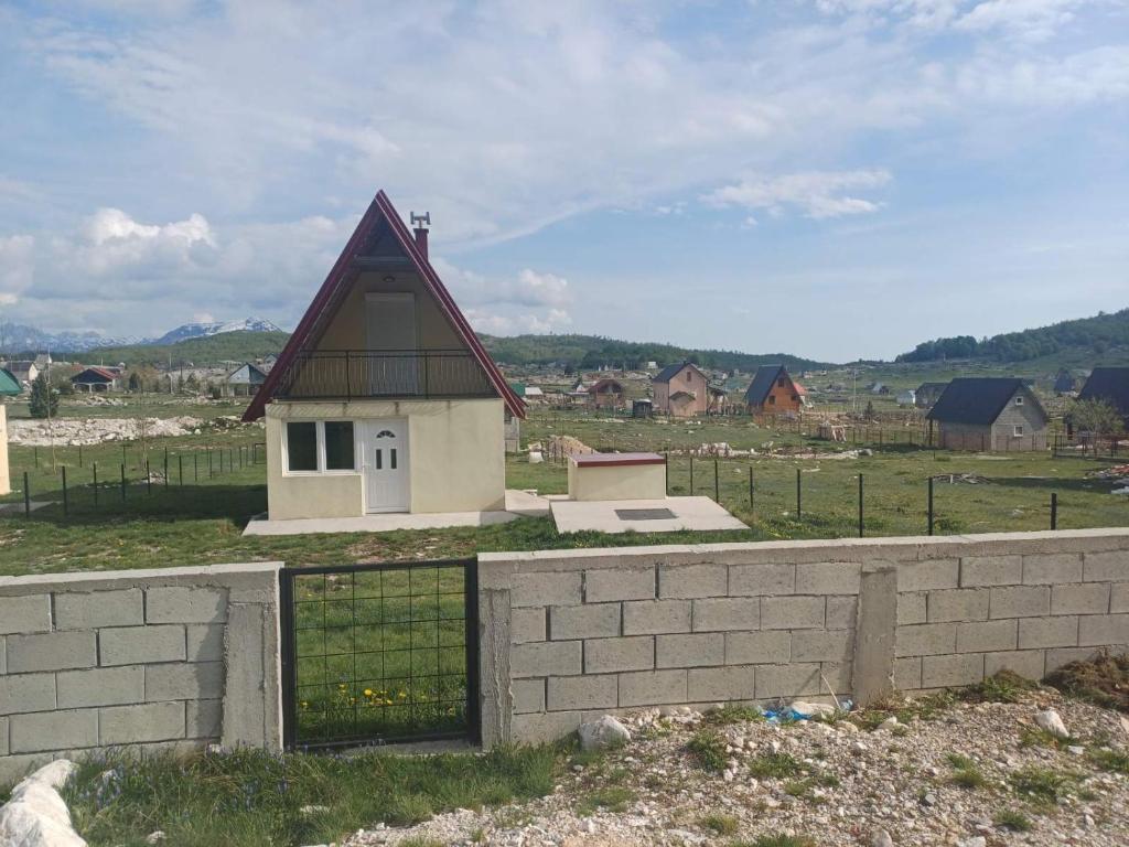 a small house on top of a brick wall at Montenegro Mountain Retreat in Podgorica
