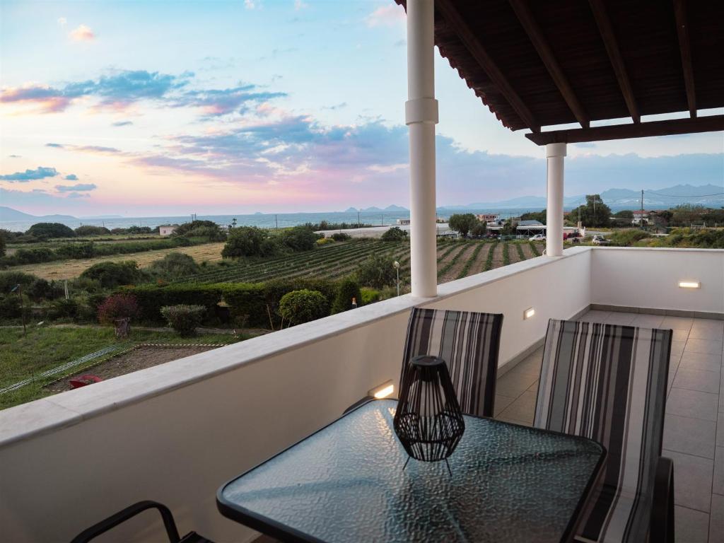 a table and chairs on a balcony with a view at Sea & Olive Retreat in Zipárion