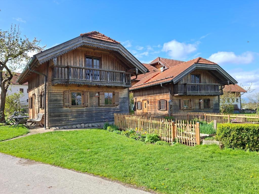 a wooden house with a fence in front of it at Ferienhaus Lenzenbauer in Salzburg