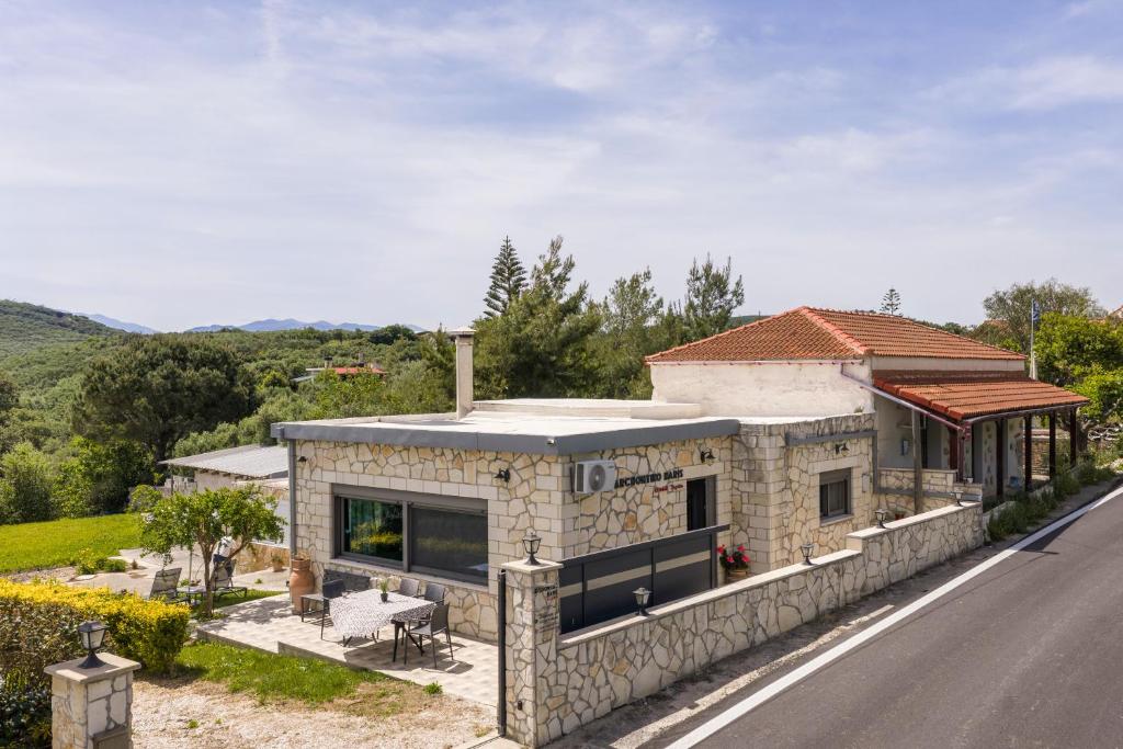 a stone house on the side of a road at Archontiko Haris in Kolymvari