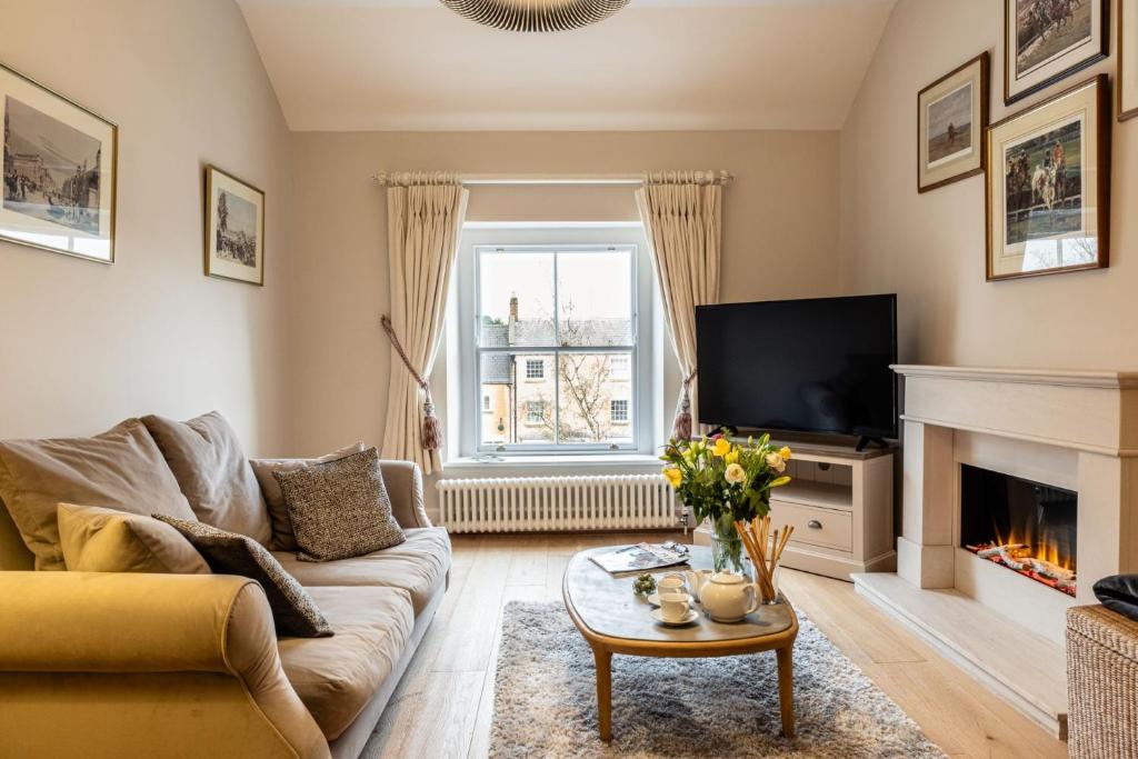 a living room with a couch and a fireplace at Topside in Moreton in Marsh