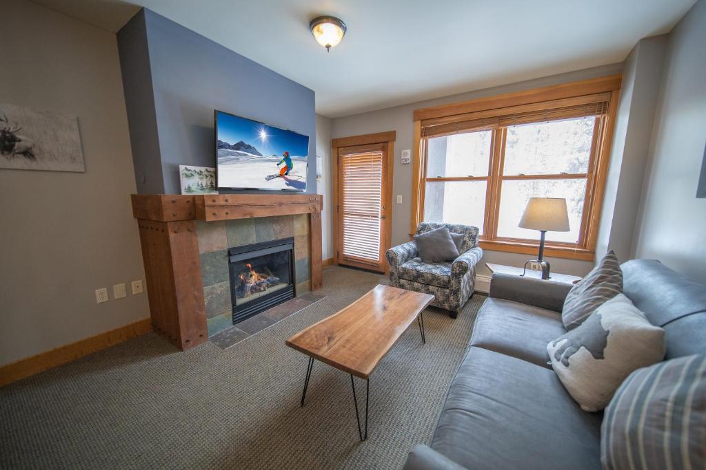 a living room with a couch and a fireplace at Springs 8806 by SummitCove Lodging in Colorado in Keystone