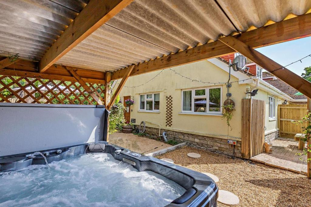 a hot tub in the backyard of a house at 2 Bed in Godshill oc-78573 in Godshill