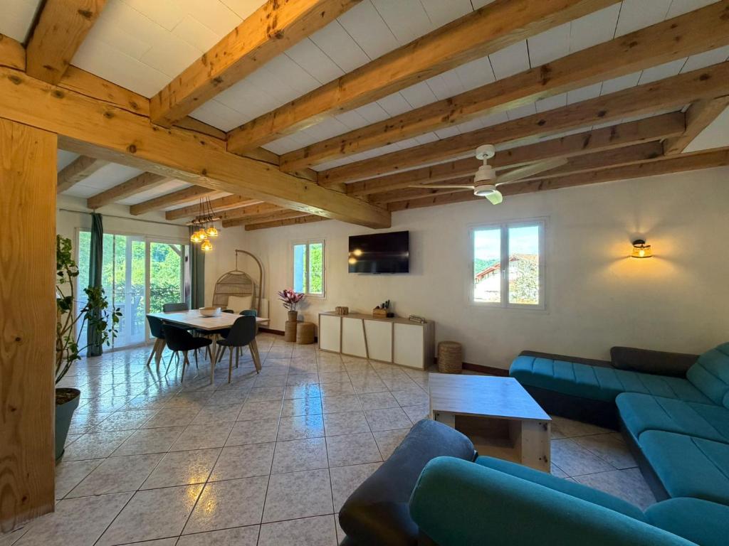 a living room with a blue couch and a table at La maison d'Artzamendi in Louhossoa