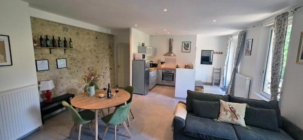a living room with a couch and a table at Maison de la Craffe in Francs