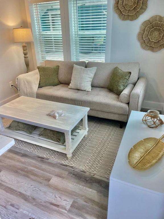 a living room with a couch and a coffee table at Lil' Beach Getaway in Jacksonville Beach