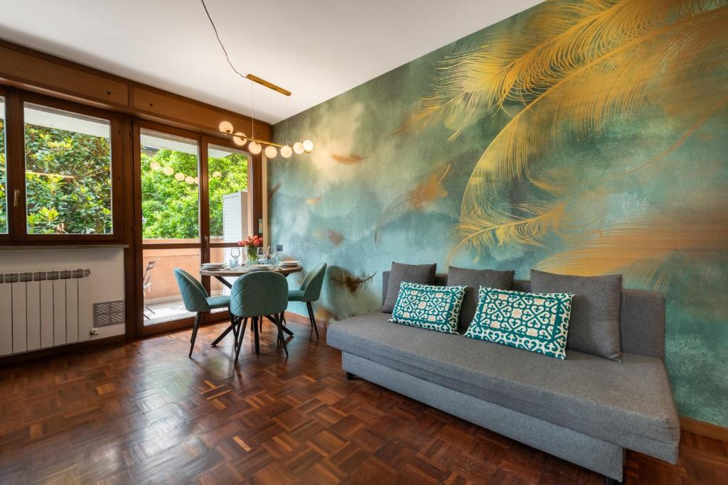 a living room with a couch and a table with a painting at Cozy Loft near MXP AIRPORT & RHO FIERA - 4 GUESTS - Parking FREE in Legnano