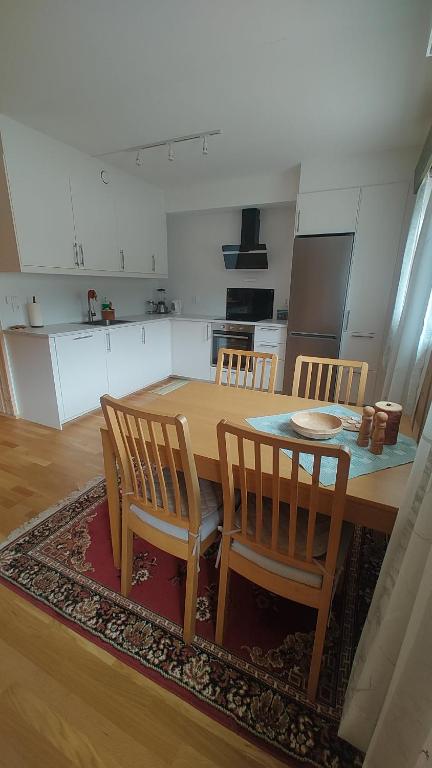 a kitchen with a wooden table and four chairs at Signegarden Bismo in Skjåk