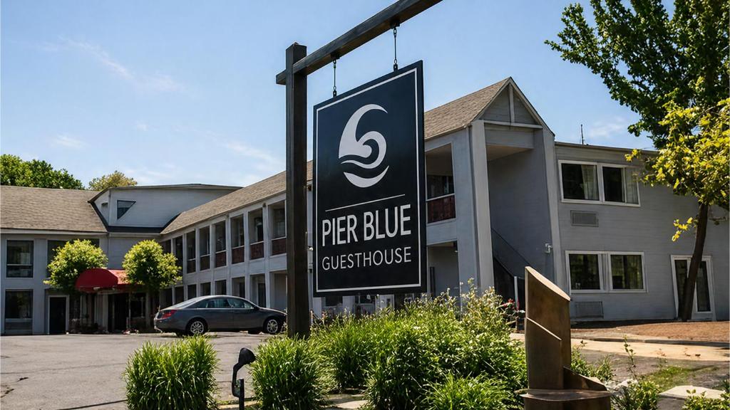a sign for a per bike business in front of a building at PIER BLUE INN Old Saybrook - Essex in Old Saybrook
