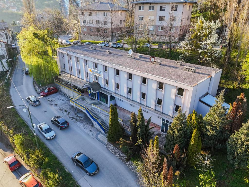 an overhead view of a building with cars on a street at Hotel Ferijalac in Sarajevo