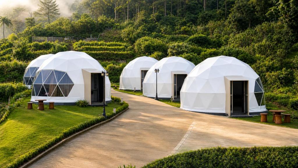 four tents in a row in a garden at Casa de Monique Glamping Resort in Bogor