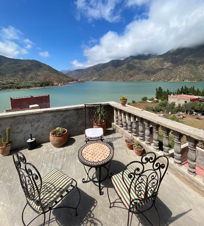 a patio with a table and chairs and a lake at lake view, comfortable artistic design in Ouirgane