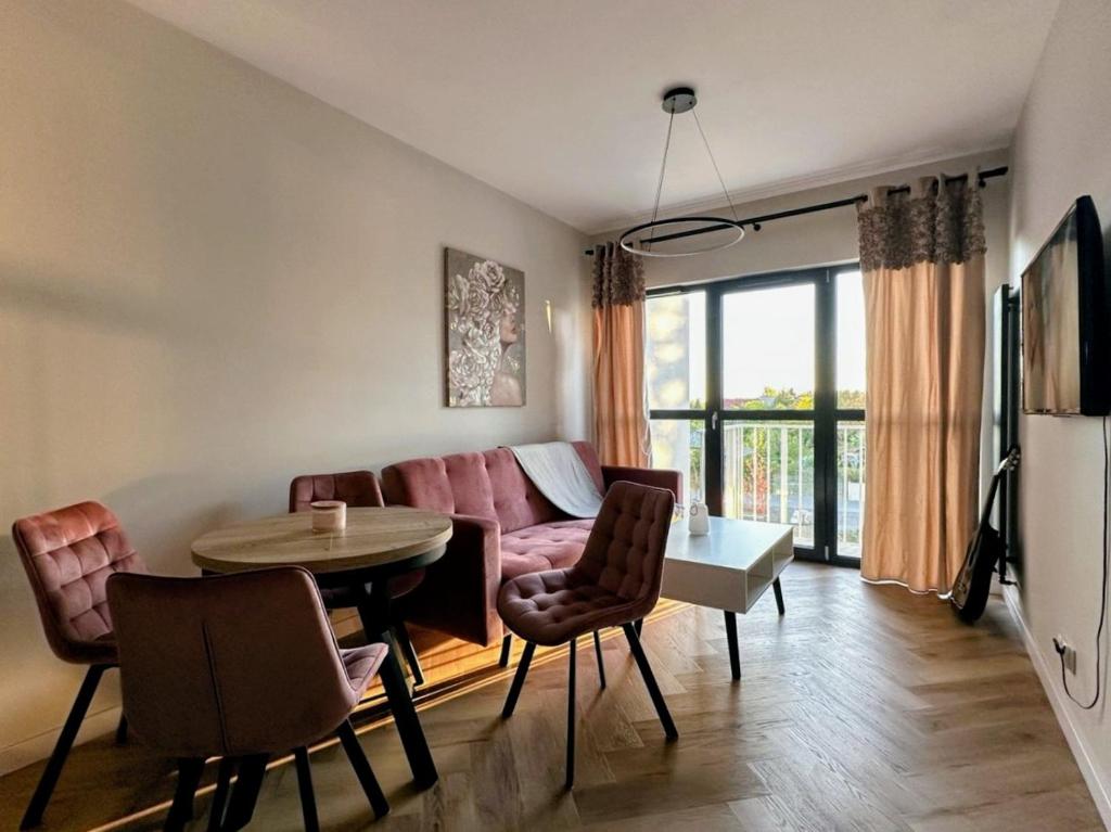 a living room with a couch and a table at Baltic Porto M66 in Gdańsk