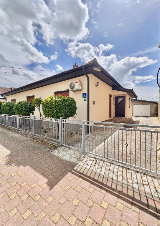 a building with a fence in front of it at GOLD Apartman - Kuća za odmor in Sanski most