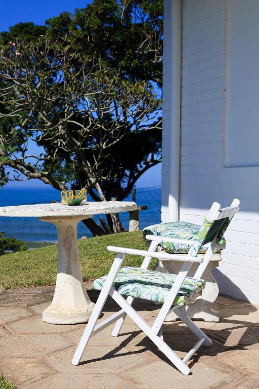 a picnic table and two chairs next to a picnic table and a table and chairs at Seaward Studio Suite in Ramsgate