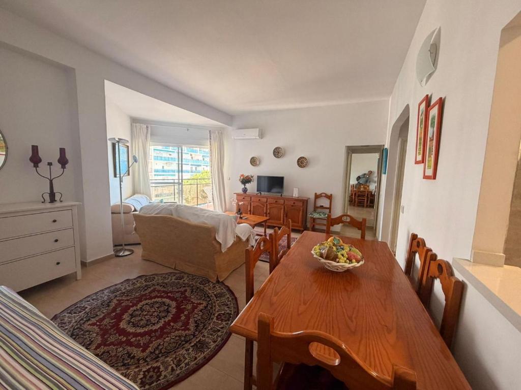 a living room with a table and a dining room at andaluz in La Mamola