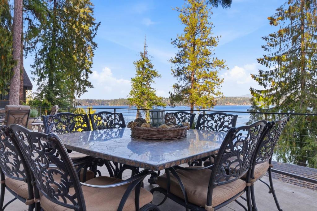 a table with chairs and a basket of fruit on it at Hayden Lake Oasis in Hayden