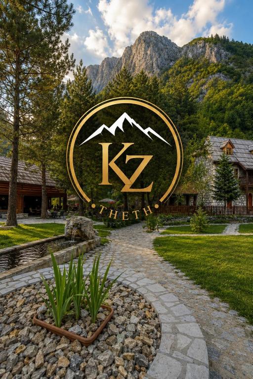 a sign for a resort with mountains in the background at Kompleksi Zorgji in Theth