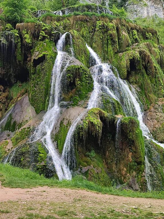 a waterfall on the side of a mountain at Chambre chez Danuta in Champagnole