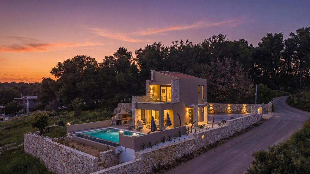 a villa with a swimming pool on a road at Moon and Sun in Vamos