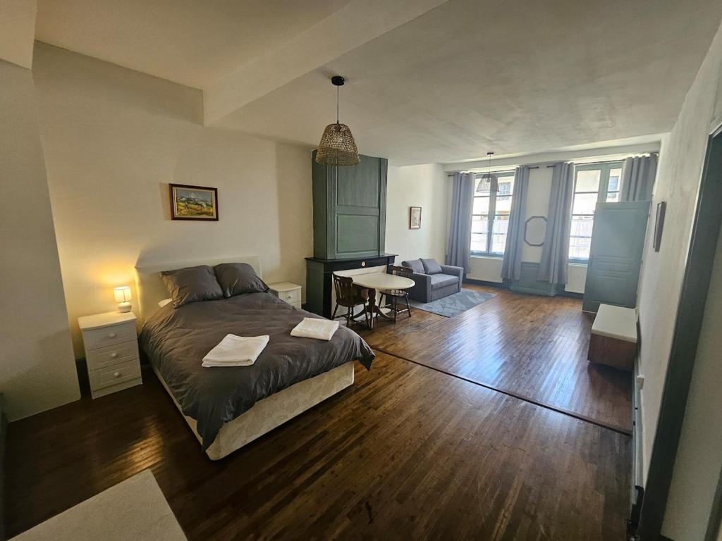 a bedroom with a bed and a desk in it at Private Apartment in Rochechouart