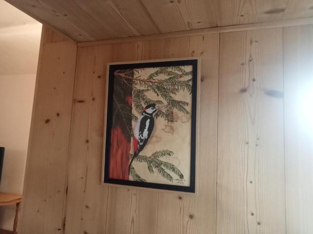 a picture of a bird hanging on a wall at Gîte Le Pic Epeiche in Saint-Roman