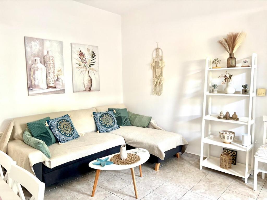 a living room with a couch and a table at Andreana's Place Rhodes in Asgourou