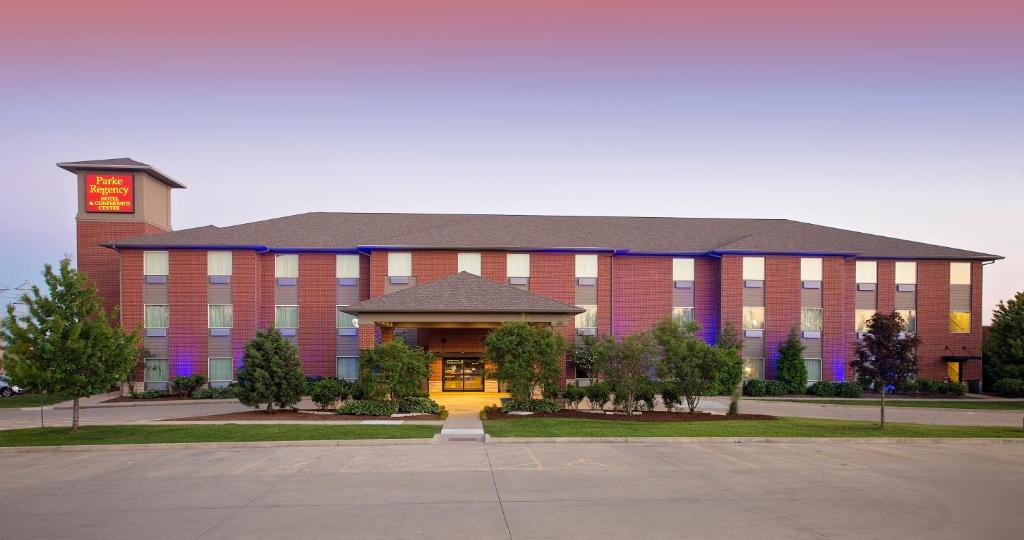 a large brick building with a clock tower on top at Parke Regency Hotel & Conference Center in Bloomington