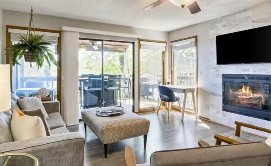 a living room with a fireplace and a tv at Full Moon Condo in Lake Ozark