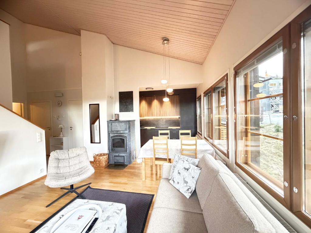 a living room with a couch and a fireplace at Ruka Center Chalet 3B4 - Ski-In Ski-Out - All services nearby - AC - Fireplace - Wifi - Own parking place in Ruka