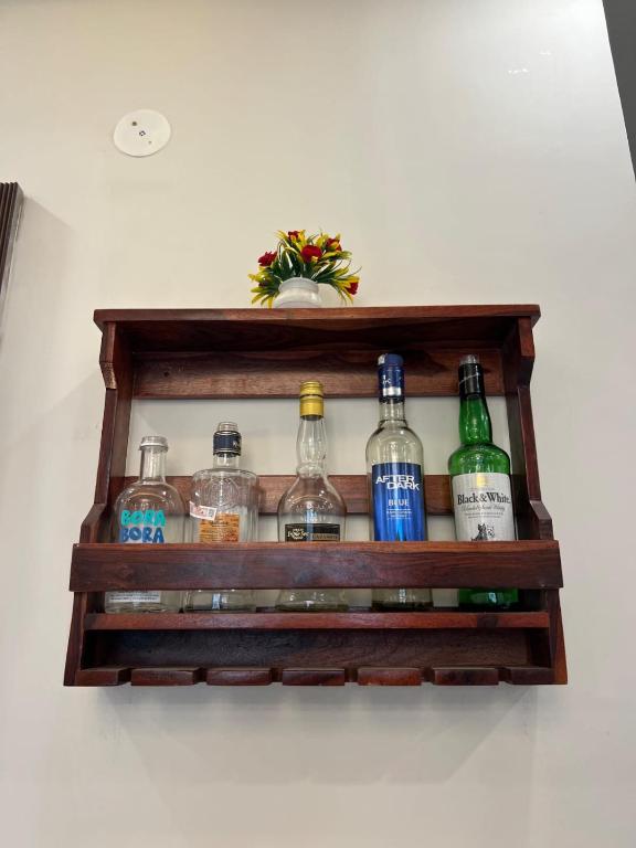 a shelf with bottles of alcohol on a wall at Starlight villa in Ghaziabad