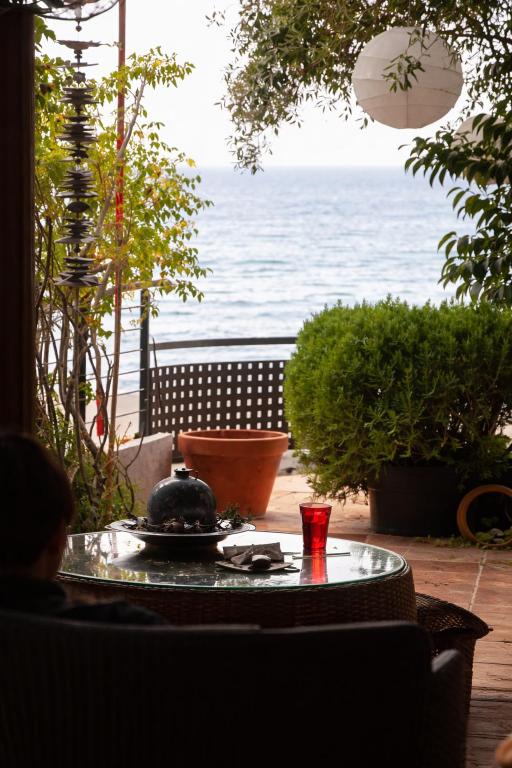 a table with a view of the ocean from a patio at Magic Mola in Mola Kalyva