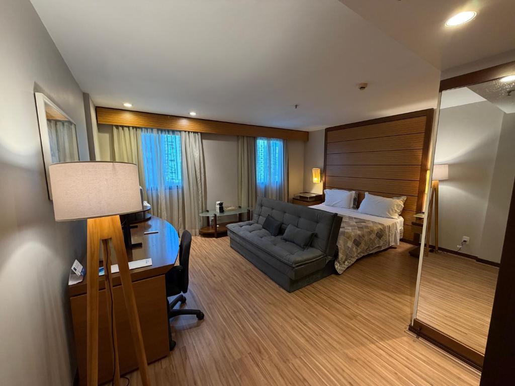 a large hotel room with a bed and a desk at Hotel Wynd Ibirapuera 512A in São Paulo