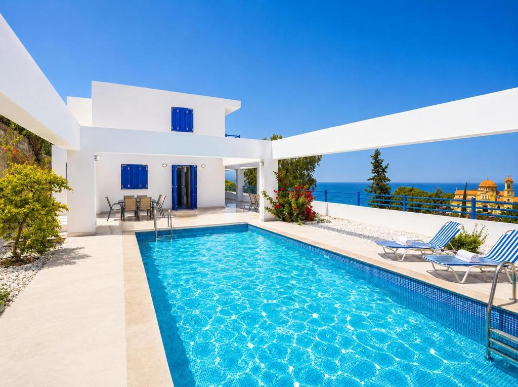 a villa with a swimming pool and a view of the ocean at Villa Eagles Nest in Pachyammos