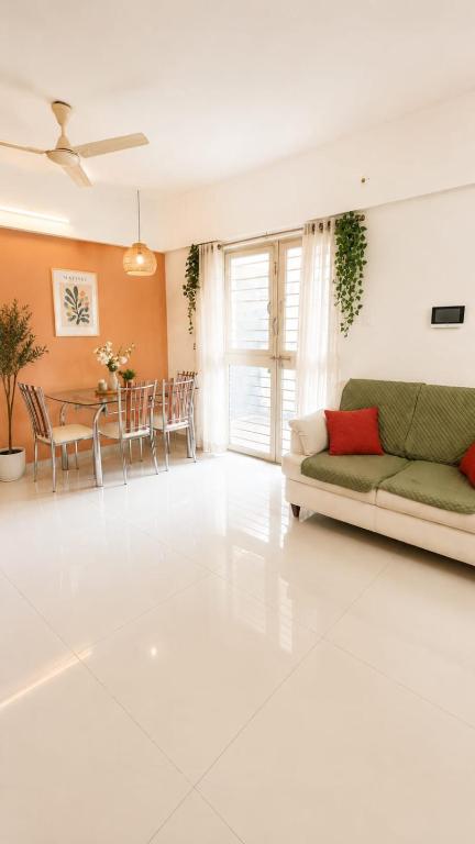 a living room with a couch and a table at Sylevo 2bhk kharadi in Pune