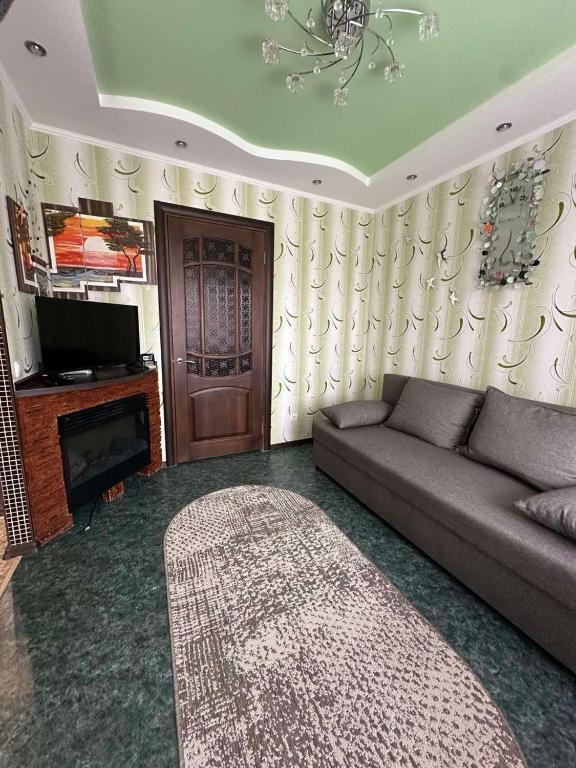 a living room with a couch and a television at Central Comfort in Konotop