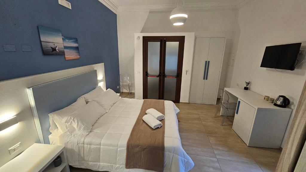 a bedroom with a bed with two towels on it at Janva Guest House in Sciacca